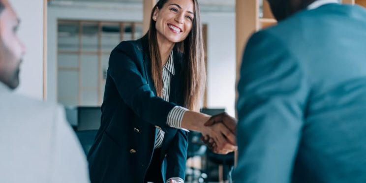 Human resources manager shaking hands with a newly hired employee