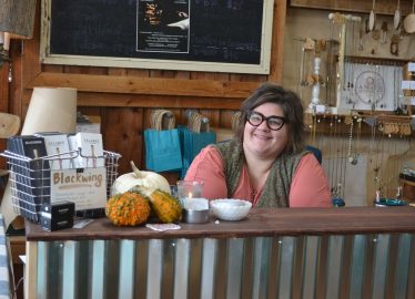 Young Woman Behind Counter in Store