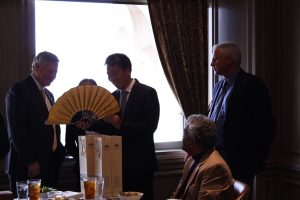 President Mike Williams inspects a traditional Chinese fan presented to the school as a gift of friendship given by Faulkner's guests from Xiangyang Vocational and Technical College in China. 