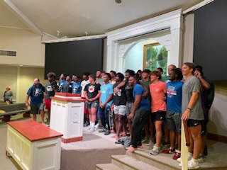 37 student athletes pose after being baptized at University Church of Christ.