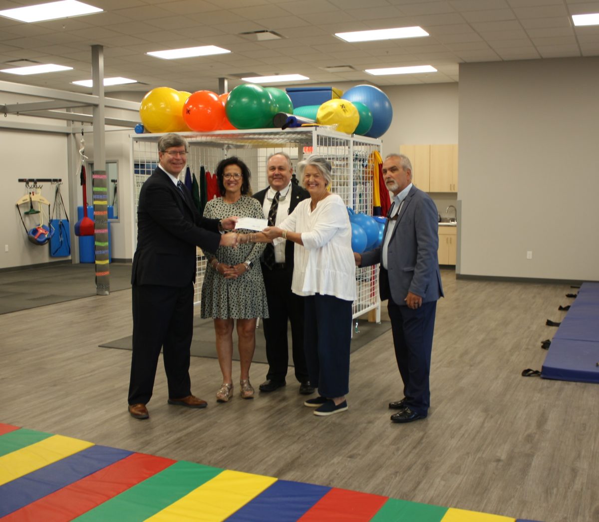 Eubanks and May families present a check to President Henry.