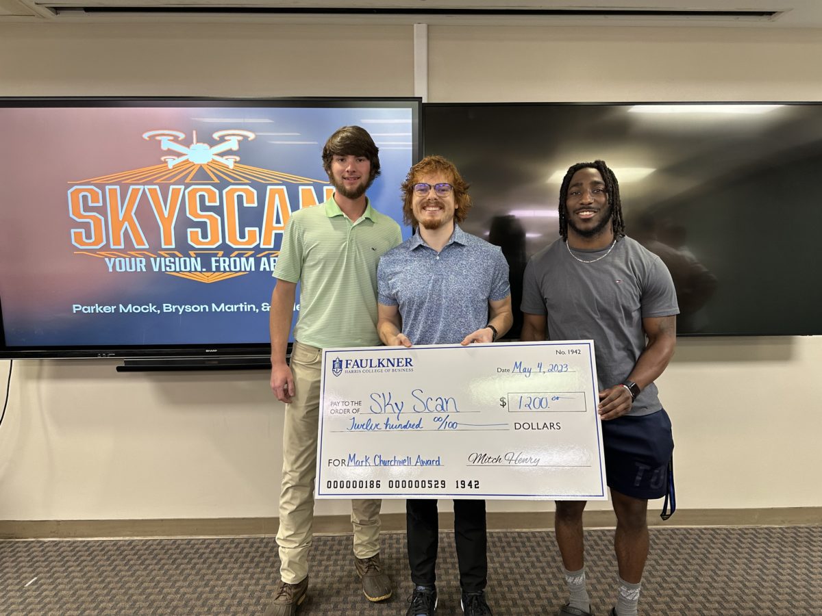 This year's recipients of the Mark Churchwell Entrepreneurship Award Parker Mock, Cole Kelley, and Fred Martin hold a check for $1,200.
