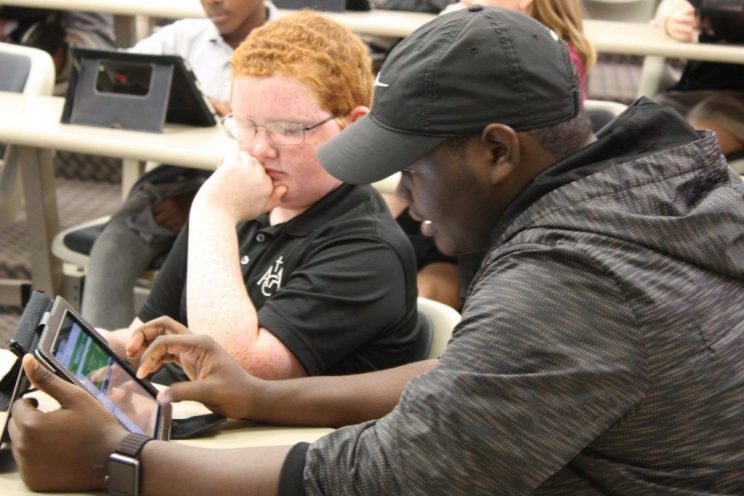 Computer Science majors help students from ACA during Hour of Code on Dec. 3, 2018.