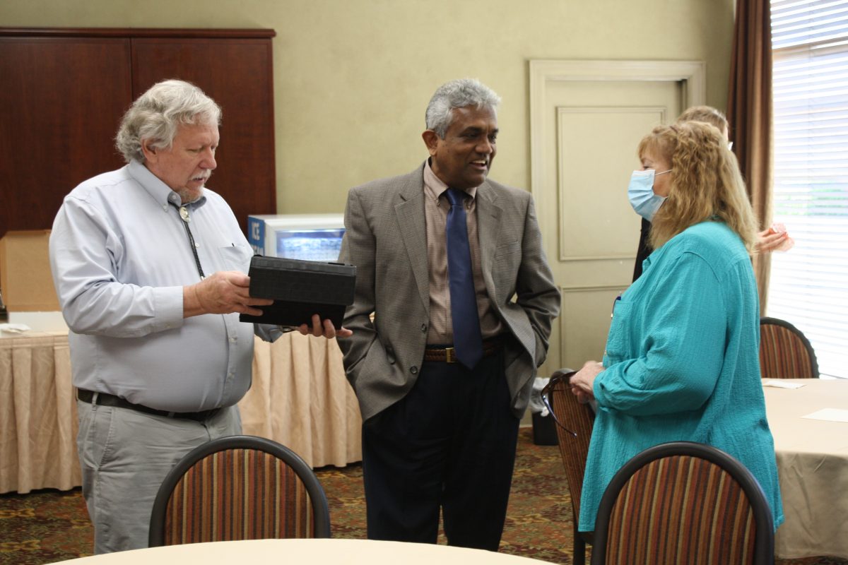 l-r Dr. Al Schlundt, Dr. Dave Rampersad and Terri Schlundt chat during Al Schlundt's retirement ceremony.