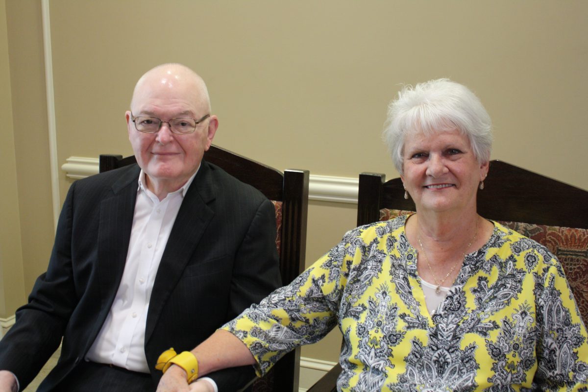 l-r Don Myers and Judy Myers sit together and hold hands during Don Myers retirement ceremony.