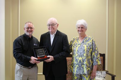 l-r Scott Gleaves, don Myers and Judy Myers. Gleaves presents Don Myers with a commemorative plaque during his retirement ceremony.