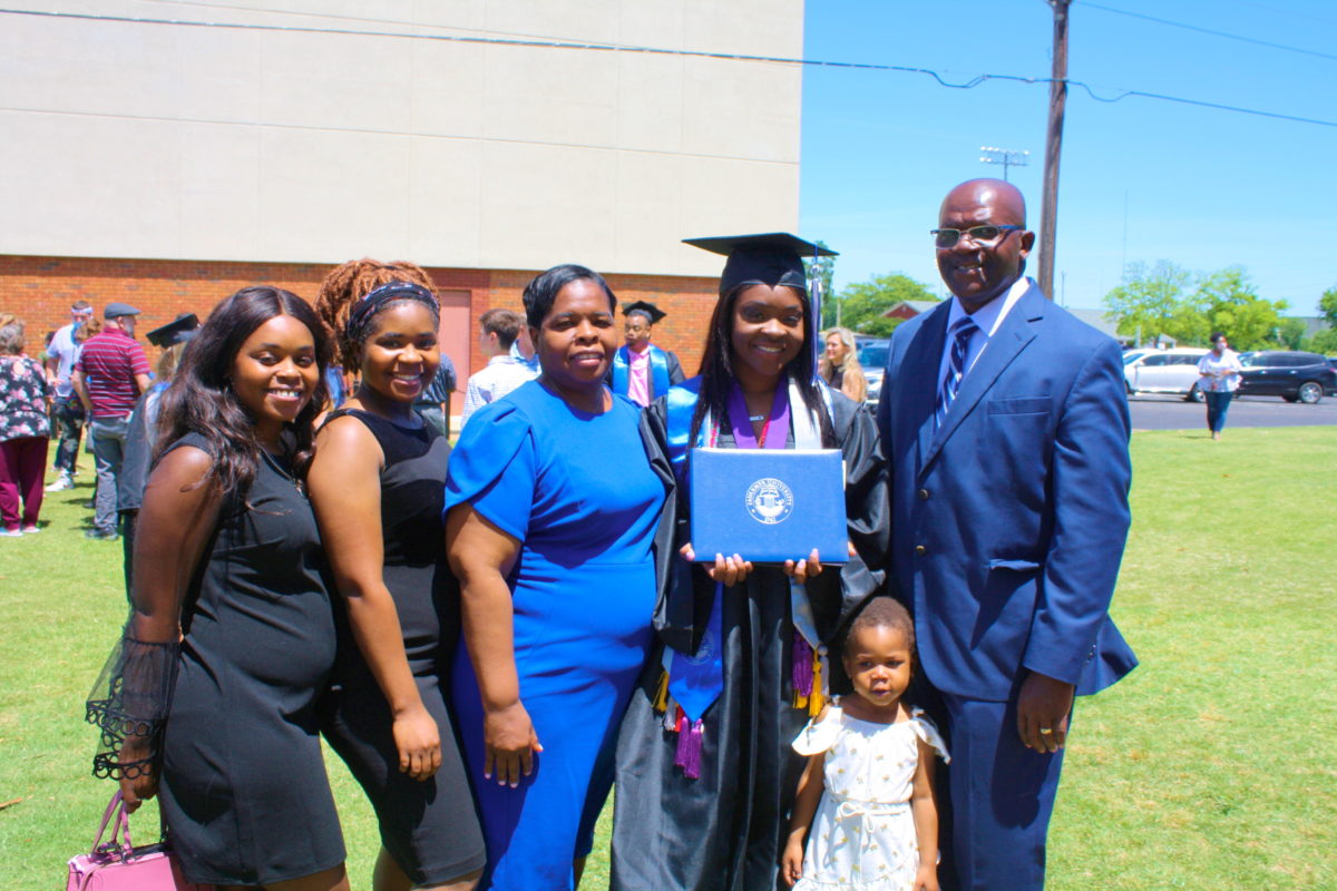 Zanesha Rhodes stands with her family after the spring 2021 commencement ceremony. 