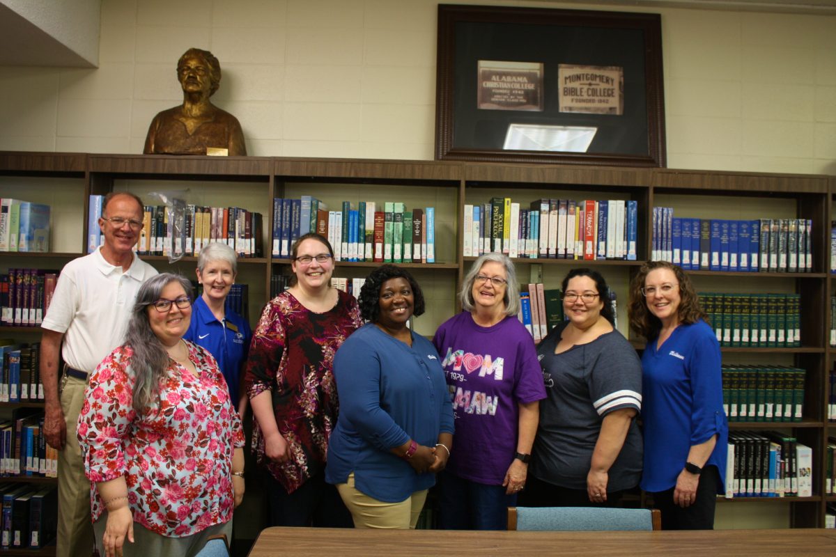 Barbara Kelly stands among her colleagues at the Gus Nichols Library.  