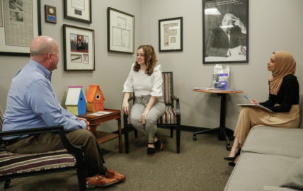 l-r Faulkner Law professor John Craft, and 3L law students Whittney Clark and Wala Hijaz pose for a mock client meeting at the Faulkner Law's Elder Law Clinic lobby