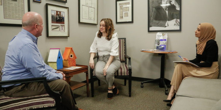 l-r Faulkner Law professor John Craft, and 3L law students Whittney Clark and Wala Hijaz pose for a mock client meeting at the Faulkner Law's Elder Law Clinic lobby