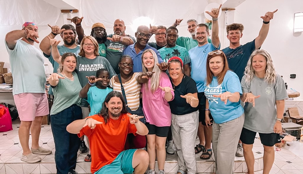 Faulkner faculty, staff, alumni and current students pose with members of Growing Faithful Children during their summer mission trip to Jamaica.