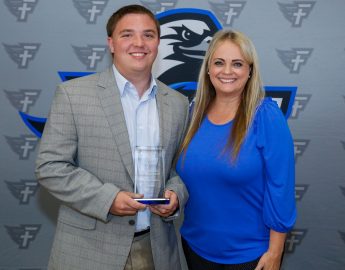 l-r Cody Davis and Dr. Donna Clemons. Davis is presented with the Young Alumnus Award for the Marketplace Faith Friday Forums. He works as a coach for Montevallo High School.