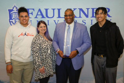 Center, Dr. Gregory Moore poses with his wife Courtney and his two sons, Damon and Derek.