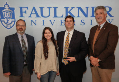 Center left, Blaine Benson is honored during the 2022 Marketplace Faith Friday Forums. He stands next to his daughter and Grover Plunkett and Dr. James Guy.