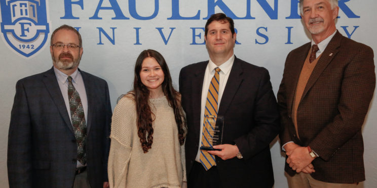 Center left, Blaine Benson is honored during the 2022 Marketplace Faith Friday Forums. He stands next to his daughter and Grover Plunkett and Dr. James Guy.