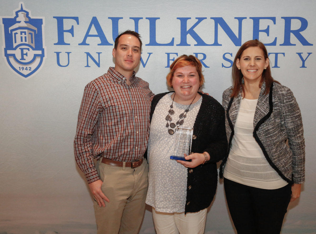 Center Kelsey Mills poses with her husband and Dr. Leslie Cowell.