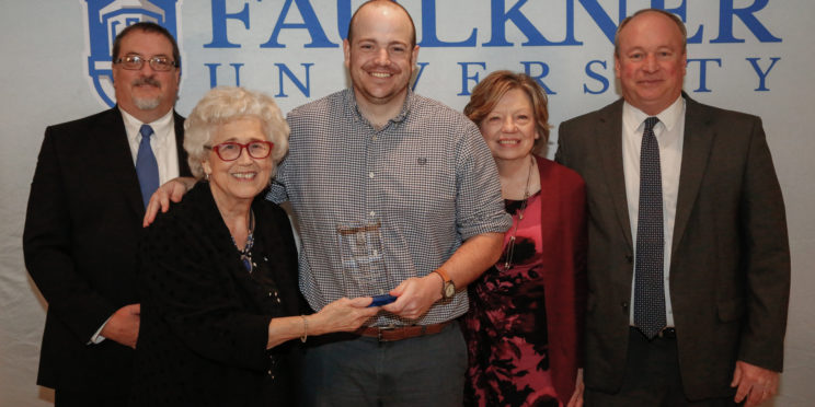 Center, Drew Phillips stands with l-r, Dr. Jeff Arrington, Dr. Elsa Price and his mom and dad, Pat and Steve Phillips.