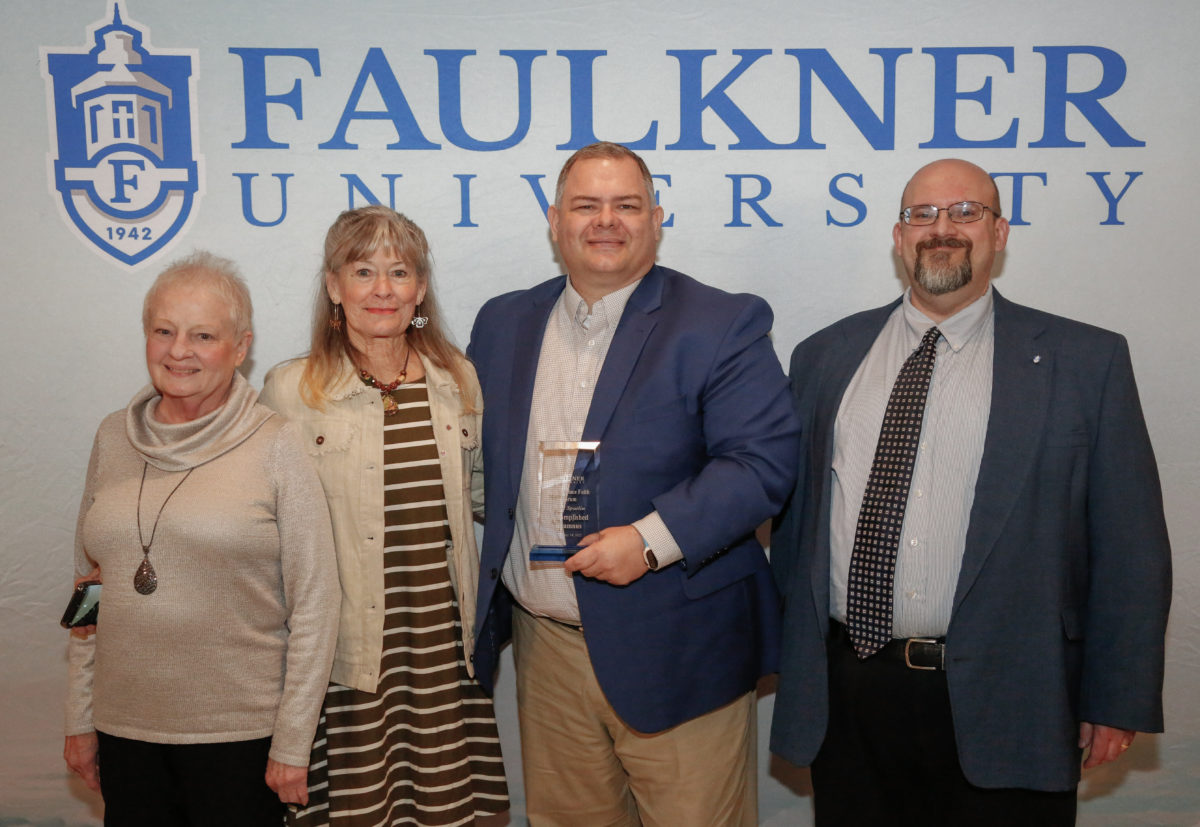 Paul Spurlin, center, stands with his family and Dr. Todd Brenneman. Spurlin is the connections minister at Piedmont Road Church of Christ. 