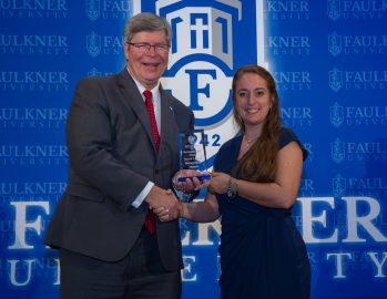 Moriah Hagel accepts the Distinguished Alumna Award.