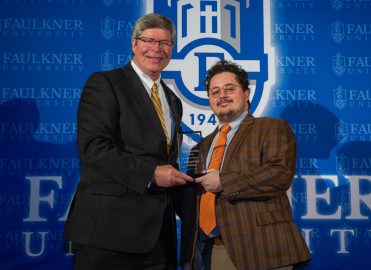 President Mitch Henry awards Jacob Payne. Payne works as a lawyer in Dothan, Alabama.