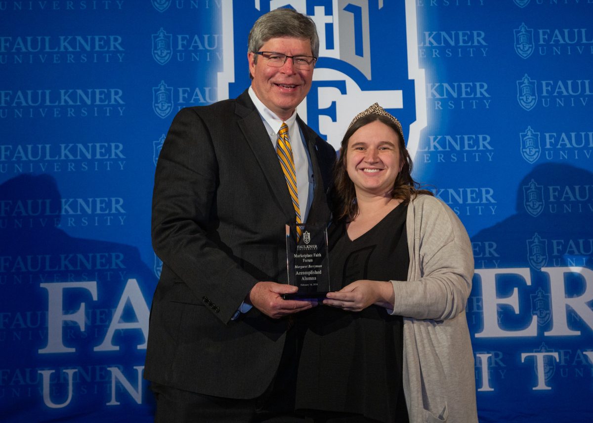 President Mitch Henry awards Margaret Berryman at the Marketplace Faith Friday Forums. 