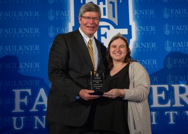 President Mitch Henry awards Margaret Berryman at the Marketplace Faith Friday Forums.