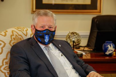 Faulkner University President Mike Williams wears a face mask with the Faulkner logo.