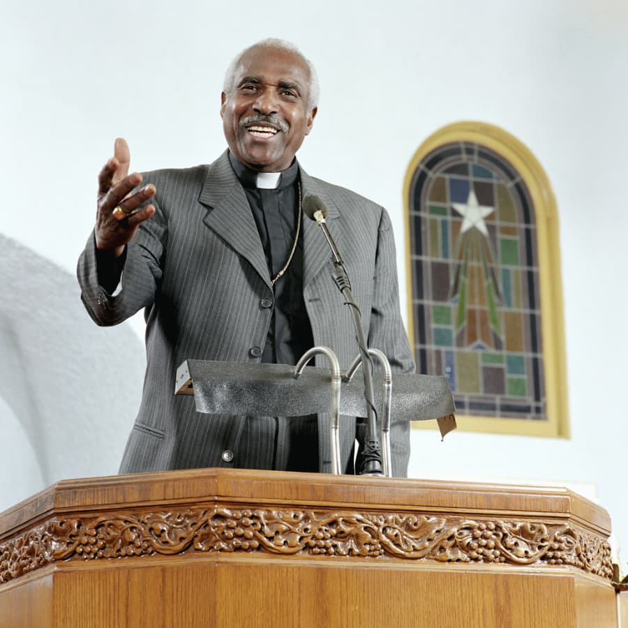 Minister giving sermon in church