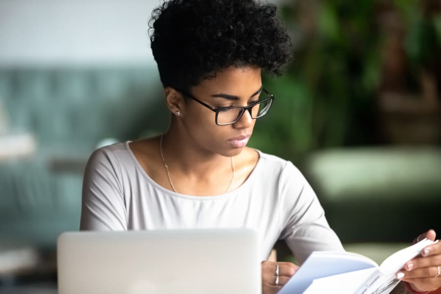 Online-Business-Degree Business Student Taking Notes On Laptop
