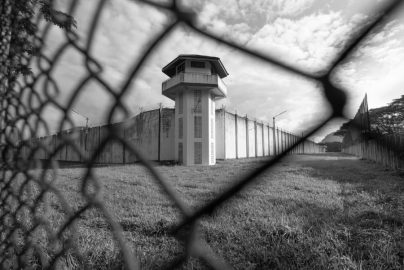 Prison watchtower behind fence