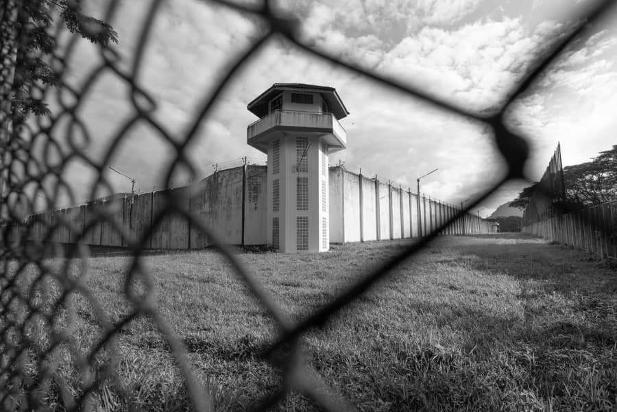 State penitentiary seen through chain-link fence