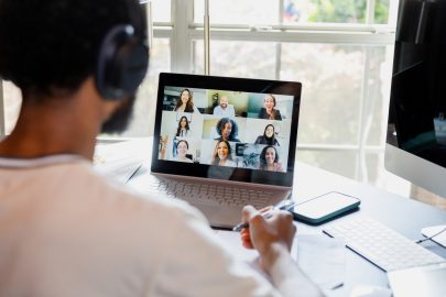 Online degree student interacts with professor and classmates via laptop from home