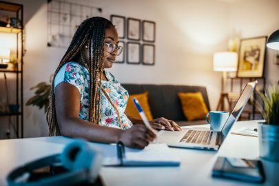 Online degree student studies with laptop at home