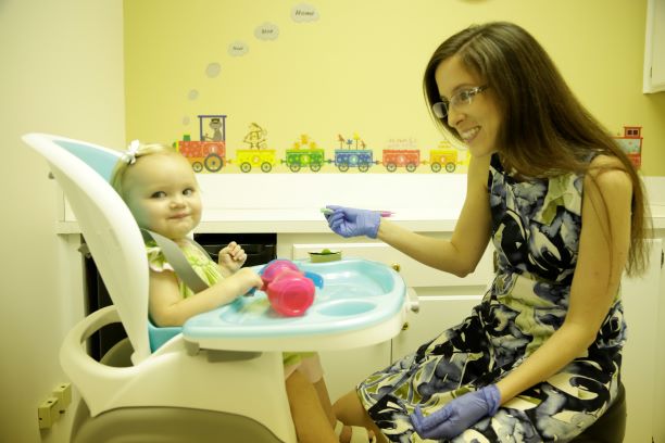 Dr. Leah Fullman administers a feeding technique to an infant patient at Faulkner University's new Speech and Language Pathology Clinic on Aug. 3.