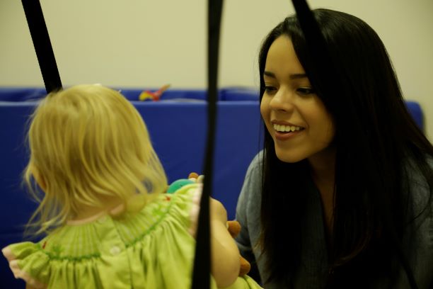 Faulkner student, Esther Barahona works with a young patient inside the clinic's fun physical therapy room.