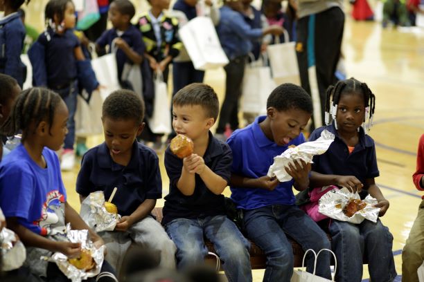 Davis students enjoy a caramel apple break at Faulkner's Fall Festival.