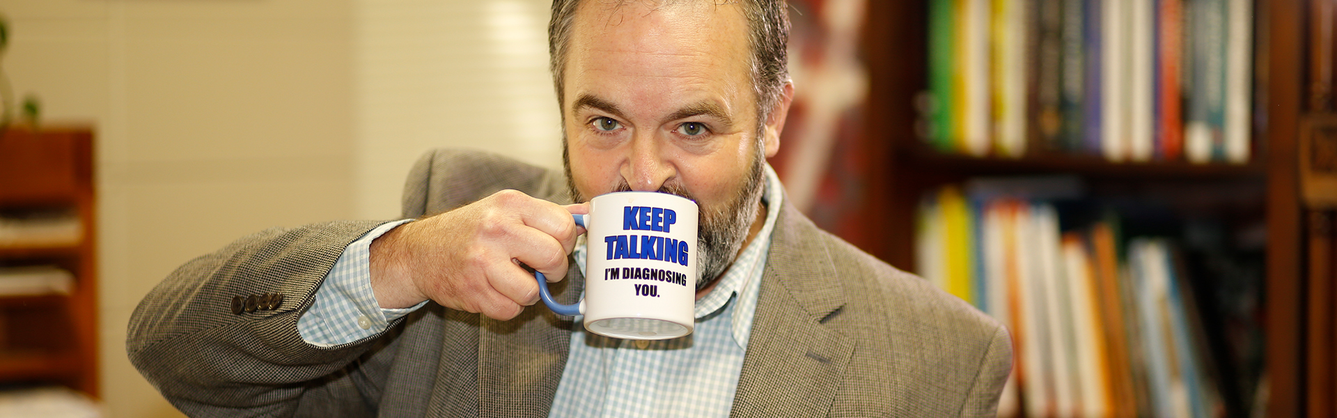 Faulkner Faculty Member Drinking From Mug