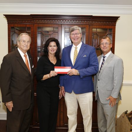 l-r- Faulkner Vice Chancellor Wayne Baker, Alabama Power Vice President of the Southern Division Leslie Sanders, Faulkner President Mitch Henry, Alabama Power External Affairs Manager Mike Jordan stand in Henry's office as they present a check to Faulkner.