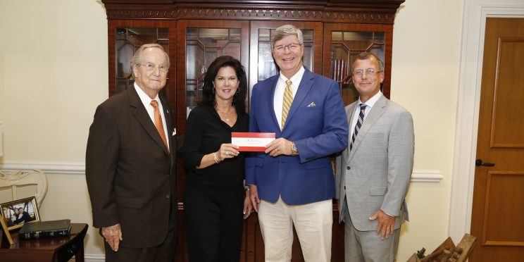 l-r- Faulkner Vice Chancellor Wayne Baker, Alabama Power Vice President of the Southern Division Leslie Sanders, Faulkner President Mitch Henry, Alabama Power External Affairs Manager Mike Jordan stand in Henry's office as they present a check to Faulkner.