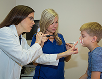 Doctors Examining Young Boy's Eyesight