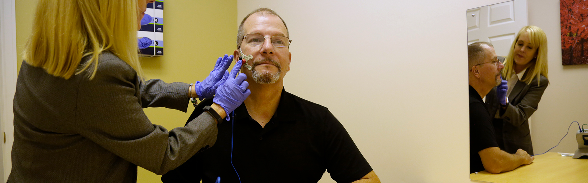 Faulkner University Pathologist performing an hearing exam