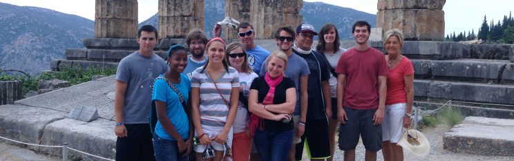 STUDY ABROAD Study Abroad Group Posing in Front of Ancient Ruins