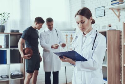 Sports psychologists talking to a basketball player in a clinic