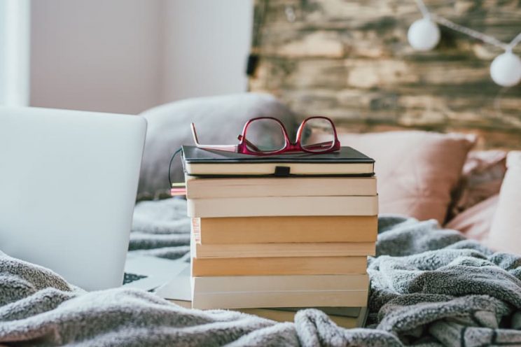 Stack of books with glasses on top