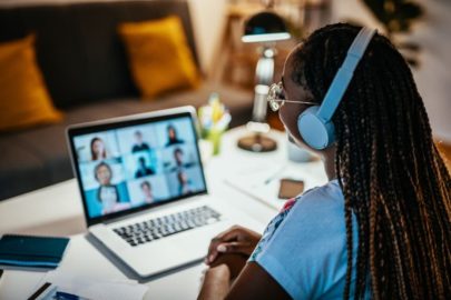 Student looking at laptop and participating in online class