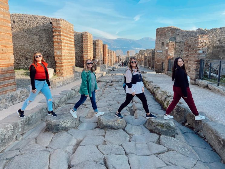 Faulkner students crossing a cobble pathway.