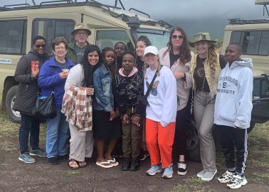 Faulkner students and group leaders, Dr. Rick Trull pose with others during their mission trip to Tanzania.