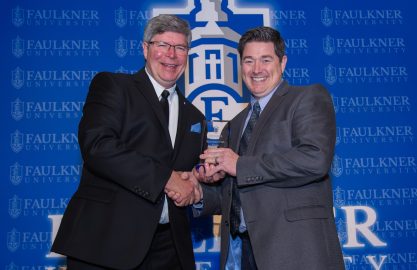 President Mitch Henry awards Trae Durden with the Distinguished Alumnus Award.