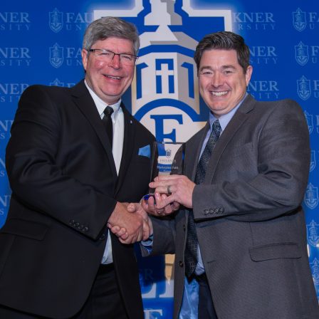 President Mitch Henry awards Trae Durden with the Distinguished Alumnus Award.