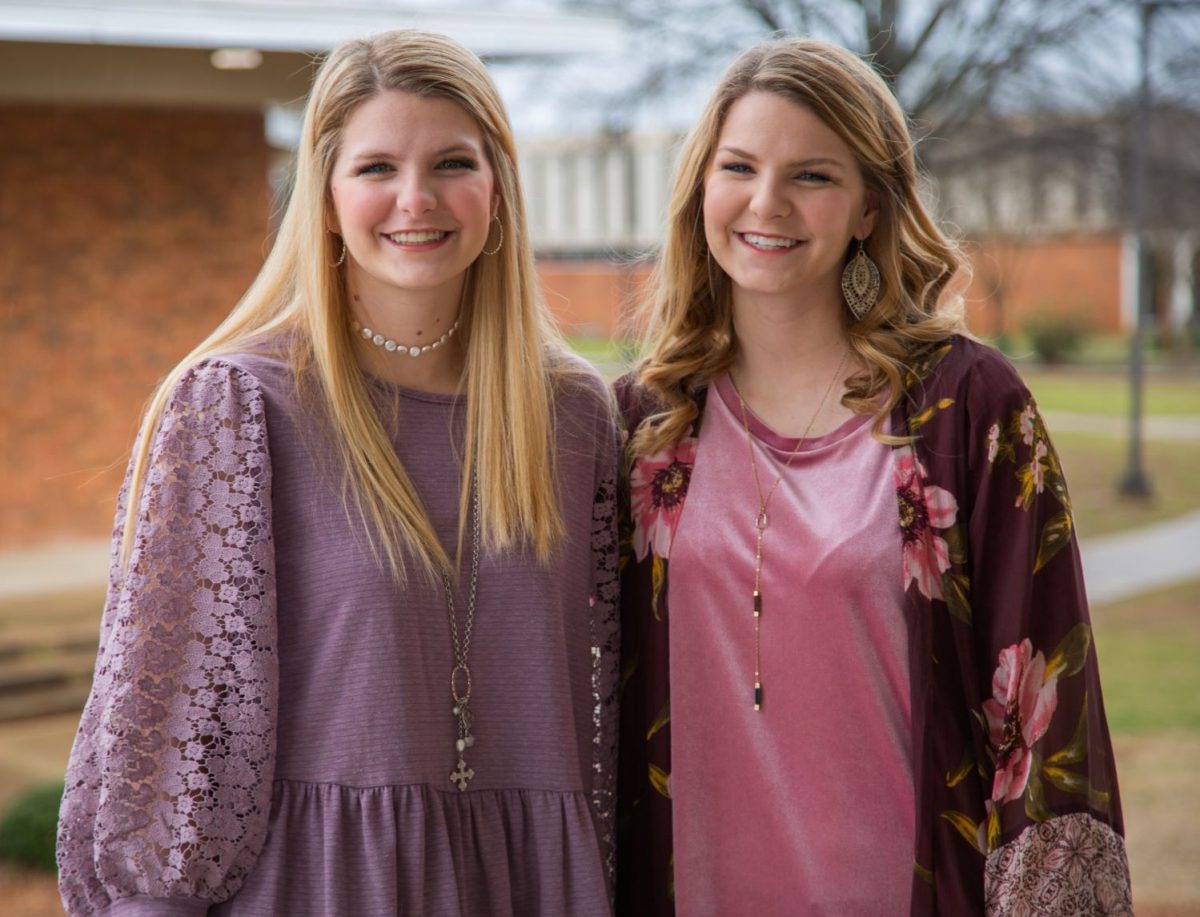 l-r: Victoria McDaniel and her sister Olivia McDaniel embrace outside the Harris College of Business building on campus. Both are Faulkner Admission Counselors and graduating seniors.